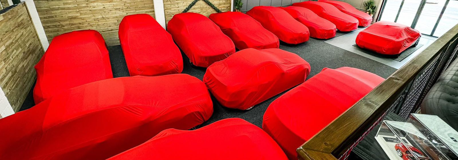Red car protected while detailing work is in progress